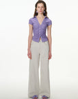 purple ruched button-front short sleeve top, on model, side view